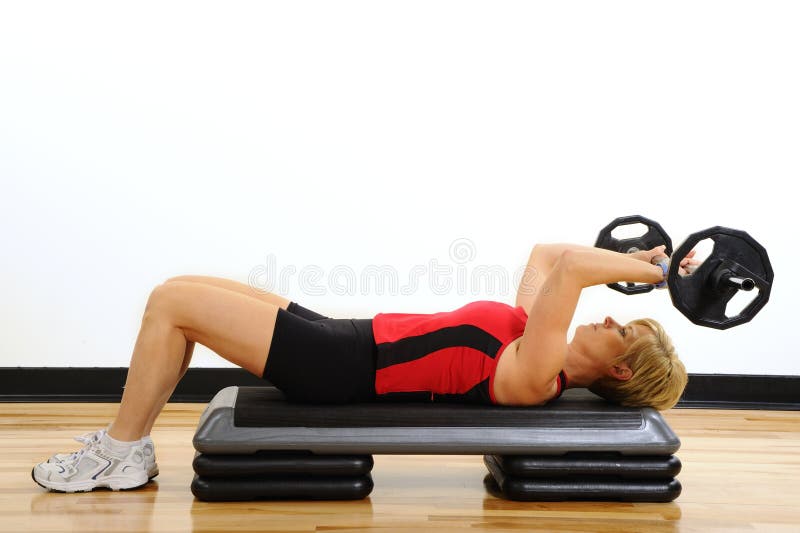 Woman lifting weights at wellness center. Woman lifting weights at wellness center