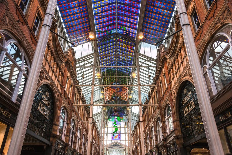 Leeds, UK - March 27, 2015: Victoria Quarter's Stained Glass Ceiling. The Quarter was restored during which a coloured glass roof was erected over Queen Victoria Street. Leeds, UK - March 27, 2015: Victoria Quarter's Stained Glass Ceiling. The Quarter was restored during which a coloured glass roof was erected over Queen Victoria Street.