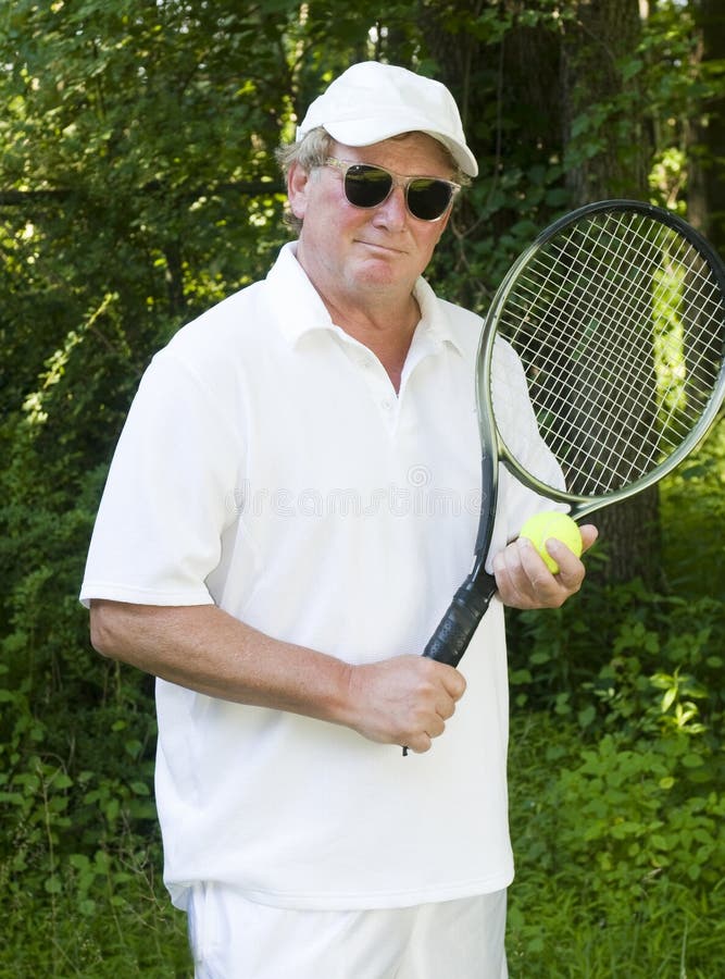 A middle age senior handsome man tennis player with tennis racket and ball. A middle age senior handsome man tennis player with tennis racket and ball