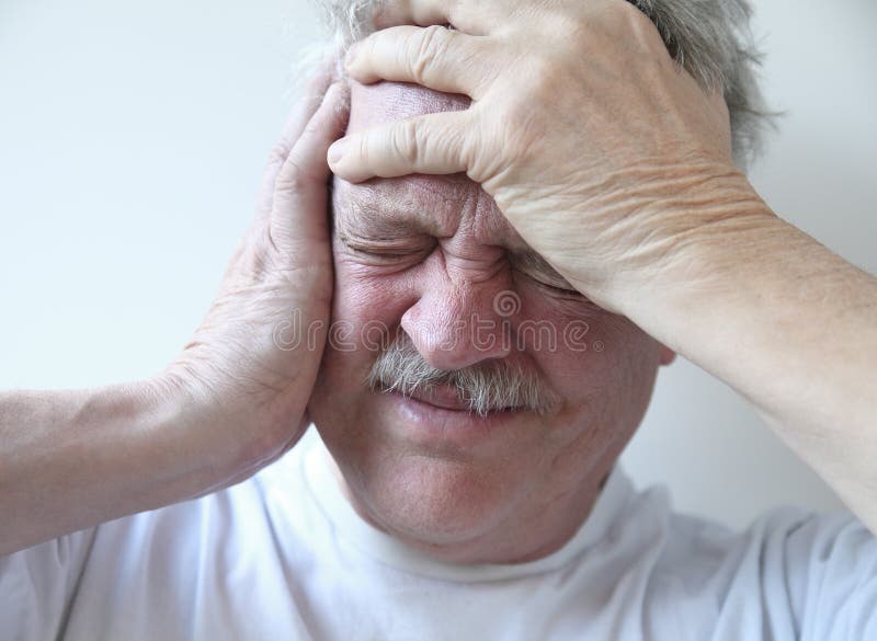 Older man suffering from pounding head pain. Older man suffering from pounding head pain