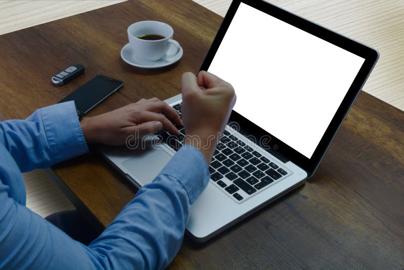 Man in his office, working with his computer. On the desk he has a coffee, his cell phone and his car keys. Achieve sales goals Celebrating good results. Man in his office, working with his computer. On the desk he has a coffee, his cell phone and his car keys. Achieve sales goals Celebrating good results