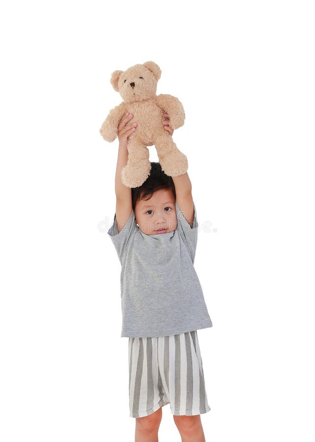 Adorable Asian little baby boy age about 3 years old lift up teddy bear doll on head isolated on white background with clipping path. Adorable Asian little baby boy age about 3 years old lift up teddy bear doll on head isolated on white background with clipping path.