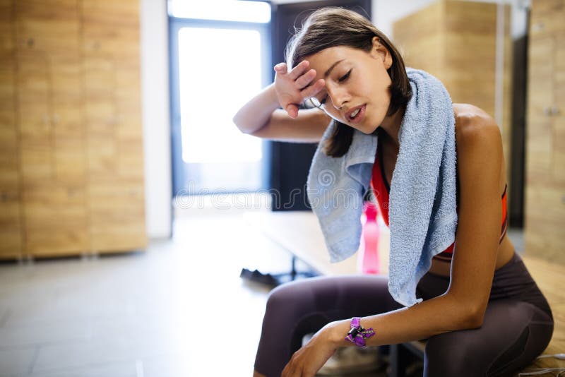 Disappointed tired woman trying to reach fitness goals by endurance and stamina training in gym. Disappointed tired woman trying to reach fitness goals by endurance and stamina training in gym