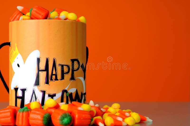 Halloween Candy and container on orange field. Halloween Candy and container on orange field