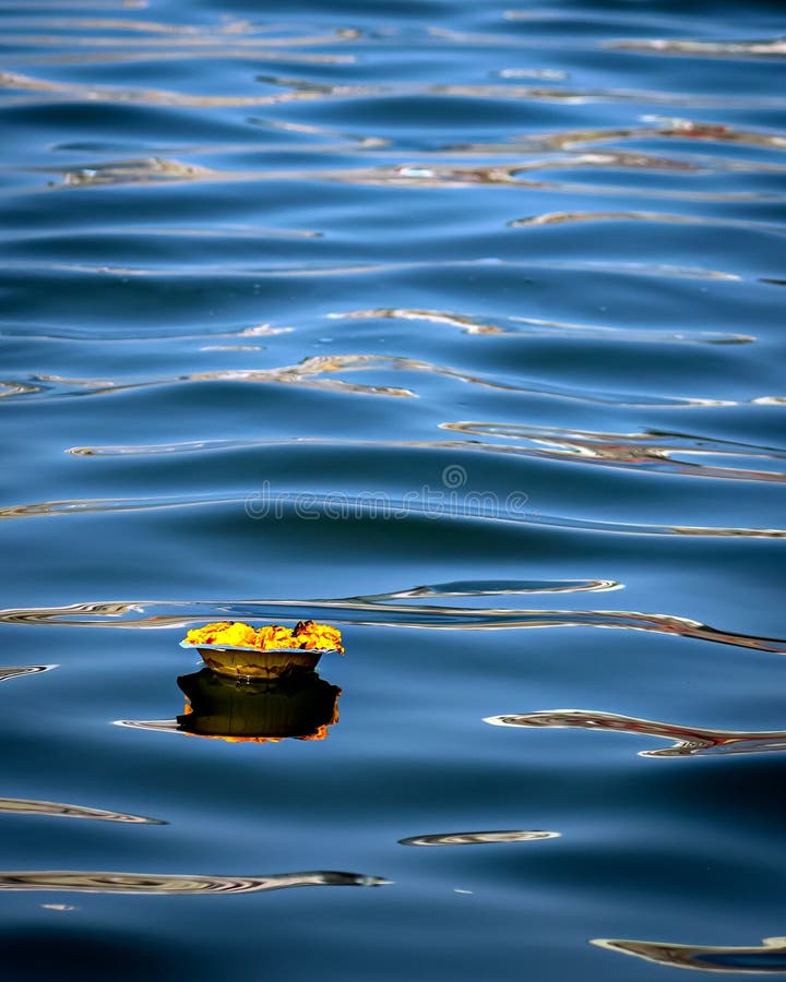 Isolated image of a floating lamp with flowers and candle offered to holy river Ganges at Varanasi Ghats. Isolated image of a floating lamp with flowers and candle offered to holy river Ganges at Varanasi Ghats.