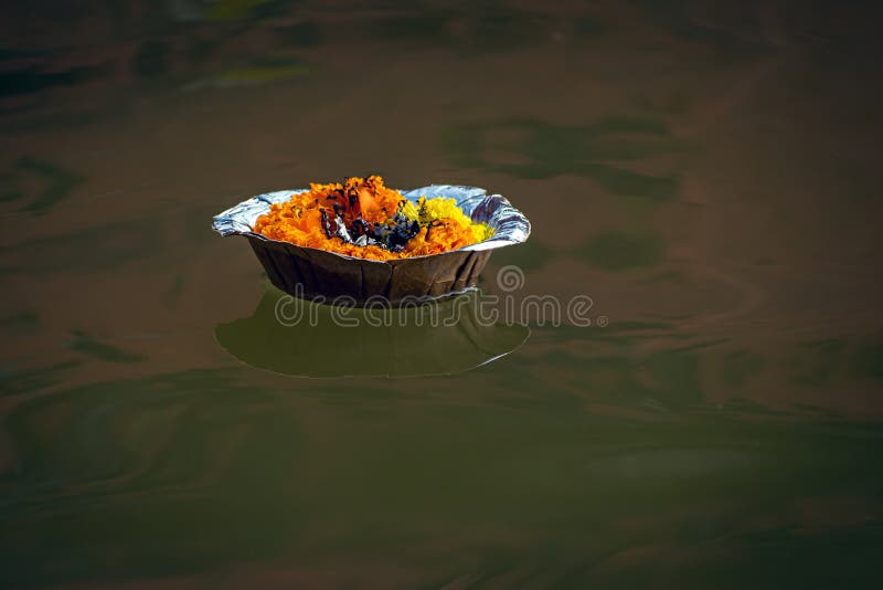 Isolated image of a floating lamp with flowers and candle offered to holy river Ganges at Varanasi Ghats. Isolated image of a floating lamp with flowers and candle offered to holy river Ganges at Varanasi Ghats.