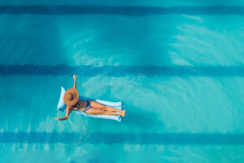 Απόλαυση suntan όμορφες νεολαίες γυναικών διακοπών λιμνών έννοιας Τοπ άποψη της λεπτής νέας γυναίκας στο μπικίνι στο μπλε στρώμα στοκ φωτογραφία Απόλαυση suntan όμορφες νεολαίες γυναικών διακοπών λιμνών έννοιας Τοπ άποψη της λεπτής νέας γυναίκας στο μπικίνι στο μπλε στρώμα στοκ φωτογραφία