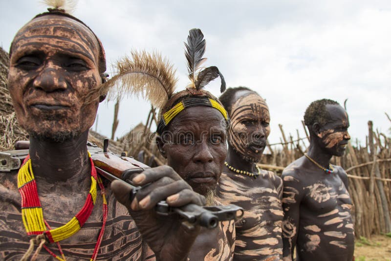 The Karo, or Kara, are a Nilotic ethnic group in Ethiopia famous for their body painting. They are also one of the smallest tribes in the region with an estimated population of 1.000-1.200 people. They are closely related to their neighbors, Hamer and Banna, with a lexical similarity of 81 They live along the east banks of the Omo River in southern Ethiopia and survive on agriculture and natural annual flooding. They have had the same culture and traditions for 500 years, like traditional dancing and painting their bodies with a mix of ash and fat or water.The Karo people differentiate themselves from many of the neighbouring tribes by excelling specifically in body and face painting. They paint themselves daily with coloured ochre, white chalk, yellow mineral rock, charcoal, and pulverized iron ore, all natural resources local to the area. The specific designs drawn on their bodies can change daily and vary in content, ranging from simple stars or lines to animal motifs, such as guinea fowl plumage, or to the most popular – a myriad of handprints covering the torso and legs. Both the Karo and the Hamar men use clay to construct elaborate hairstyles and headdresses for themselves, signifying status, beauty, and bravery.The photo is part of the album `SECOND ETHIOPIAN TRIBES EXPEDITION`. The Karo, or Kara, are a Nilotic ethnic group in Ethiopia famous for their body painting. They are also one of the smallest tribes in the region with an estimated population of 1.000-1.200 people. They are closely related to their neighbors, Hamer and Banna, with a lexical similarity of 81 They live along the east banks of the Omo River in southern Ethiopia and survive on agriculture and natural annual flooding. They have had the same culture and traditions for 500 years, like traditional dancing and painting their bodies with a mix of ash and fat or water.The Karo people differentiate themselves from many of the neighbouring tribes by excelling specifically in body and face painting. They paint themselves daily with coloured ochre, white chalk, yellow mineral rock, charcoal, and pulverized iron ore, all natural resources local to the area. The specific designs drawn on their bodies can change daily and vary in content, ranging from simple stars or lines to animal motifs, such as guinea fowl plumage, or to the most popular – a myriad of handprints covering the torso and legs. Both the Karo and the Hamar men use clay to construct elaborate hairstyles and headdresses for themselves, signifying status, beauty, and bravery.The photo is part of the album `SECOND ETHIOPIAN TRIBES EXPEDITION`