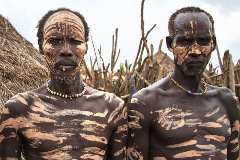 The Karo, or Kara, are a Nilotic ethnic group in Ethiopia famous for their body painting. They are also one of the smallest tribes in the region with an estimated population of 1.000-1.200 people. They are closely related to their neighbors, Hamer and Banna, with a lexical similarity of 81 They live along the east banks of the Omo River in southern Ethiopia and survive on agriculture and natural annual flooding. They have had the same culture and traditions for 500 years, like traditional dancing and painting their bodies with a mix of ash and fat or water.The Karo people differentiate themselves from many of the neighbouring tribes by excelling specifically in body and face painting. They paint themselves daily with coloured ochre, white chalk, yellow mineral rock, charcoal, and pulverized iron ore, all natural resources local to the area. The specific designs drawn on their bodies can change daily and vary in content, ranging from simple stars or lines to animal motifs, such as guinea fowl plumage, or to the most popular – a myriad of handprints covering the torso and legs. Both the Karo and the Hamar men use clay to construct elaborate hairstyles and headdresses for themselves, signifying status, beauty, and bravery.The photo is part of the album `SECOND ETHIOPIAN TRIBES EXPEDITION`. The Karo, or Kara, are a Nilotic ethnic group in Ethiopia famous for their body painting. They are also one of the smallest tribes in the region with an estimated population of 1.000-1.200 people. They are closely related to their neighbors, Hamer and Banna, with a lexical similarity of 81 They live along the east banks of the Omo River in southern Ethiopia and survive on agriculture and natural annual flooding. They have had the same culture and traditions for 500 years, like traditional dancing and painting their bodies with a mix of ash and fat or water.The Karo people differentiate themselves from many of the neighbouring tribes by excelling specifically in body and face painting. They paint themselves daily with coloured ochre, white chalk, yellow mineral rock, charcoal, and pulverized iron ore, all natural resources local to the area. The specific designs drawn on their bodies can change daily and vary in content, ranging from simple stars or lines to animal motifs, such as guinea fowl plumage, or to the most popular – a myriad of handprints covering the torso and legs. Both the Karo and the Hamar men use clay to construct elaborate hairstyles and headdresses for themselves, signifying status, beauty, and bravery.The photo is part of the album `SECOND ETHIOPIAN TRIBES EXPEDITION`