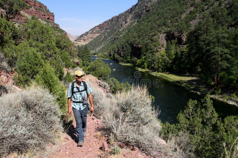 Male hiker on a trail by Green River near Flaming Gorge Reservoir, Utah, USA. Male hiker on a trail by Green River near Flaming Gorge Reservoir, Utah, USA.