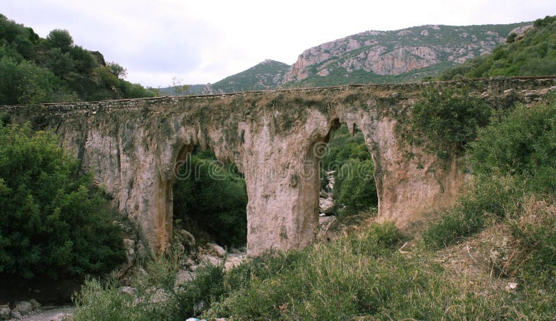 An ancient bridge in Greece near Tripoli. It appears not to be man made. Has a little bit of water running through it. An ancient bridge in Greece near Tripoli. It appears not to be man made. Has a little bit of water running through it.