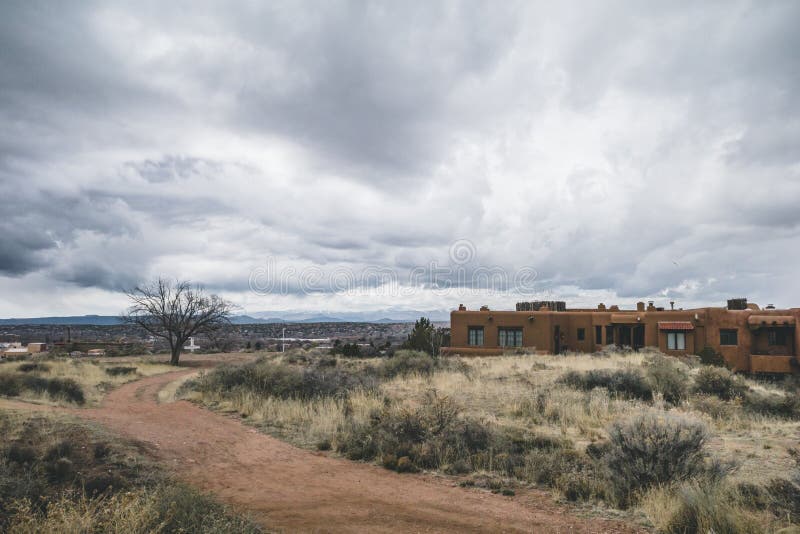 Pueblo style houses under clouds in Prince Park near downtown Santa Fe, New Mexico, USA. Pueblo style houses under clouds in Prince Park near downtown Santa Fe, New Mexico, USA