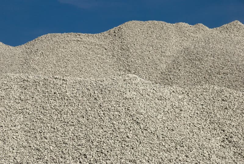 Piles of limestone gravel close to a lime stone quarry on the island of Gotland, Sweden. Piles of limestone gravel close to a lime stone quarry on the island of Gotland, Sweden