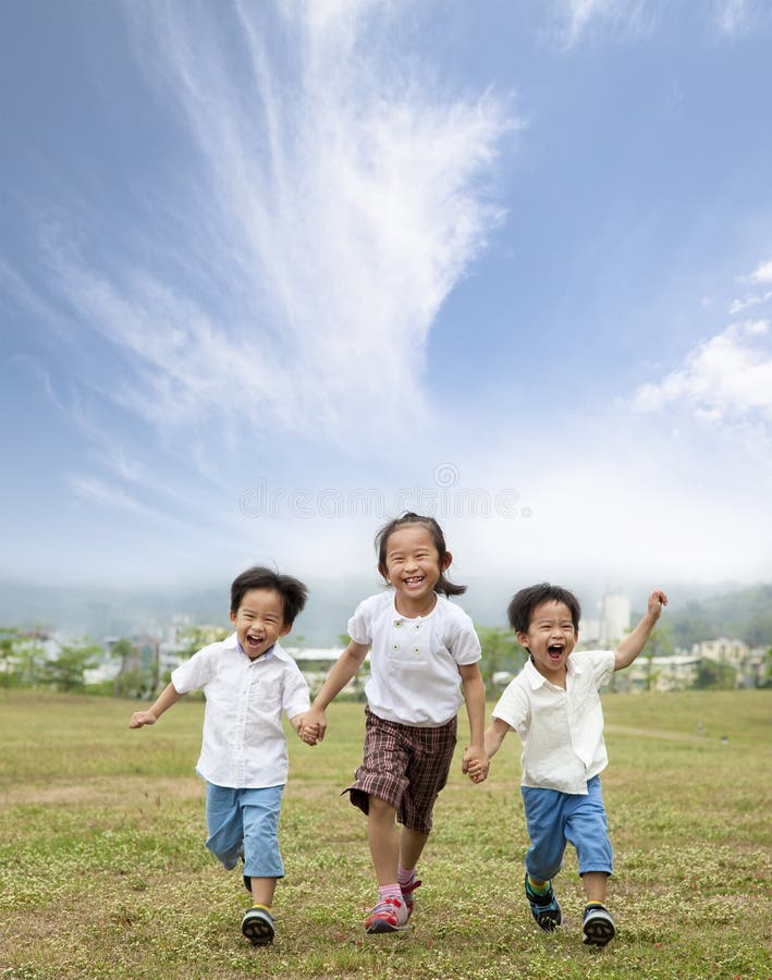 Happy running asian kids and cloud background. Happy running asian kids and cloud background