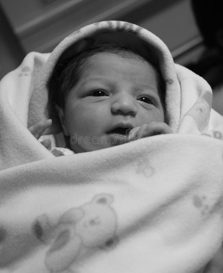New born asian baby girl. Baby is few hour old. A black and white image. New born asian baby girl. Baby is few hour old. A black and white image.