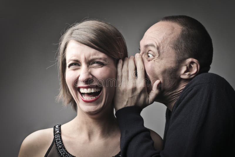 Man telling a laughing women a joke. Man telling a laughing women a joke