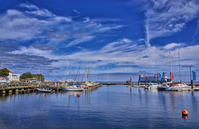 City port and sailing ships in Rostock. Warnemünde, Germany, blue, clouds, mecklenburg-vorpommern, warnemünde, background, beach, water, summer, nature, spring, architecture, baltic, coast, holiday, journey, landmark, lighthouse, pomerania, sea, sky, tourism, travel, vacation, balticsea, harbor, industry, landscape, maritime, mecklenburg-west, ostsee, popular, resort, boat, buildings, cityscape, europe, fishingboat, hanseatic, idyll, relax, river, town, transportation, view. City port and sailing ships in Rostock. Warnemünde, Germany, blue, clouds, mecklenburg-vorpommern, warnemünde, background, beach, water, summer, nature, spring, architecture, baltic, coast, holiday, journey, landmark, lighthouse, pomerania, sea, sky, tourism, travel, vacation, balticsea, harbor, industry, landscape, maritime, mecklenburg-west, ostsee, popular, resort, boat, buildings, cityscape, europe, fishingboat, hanseatic, idyll, relax, river, town, transportation, view