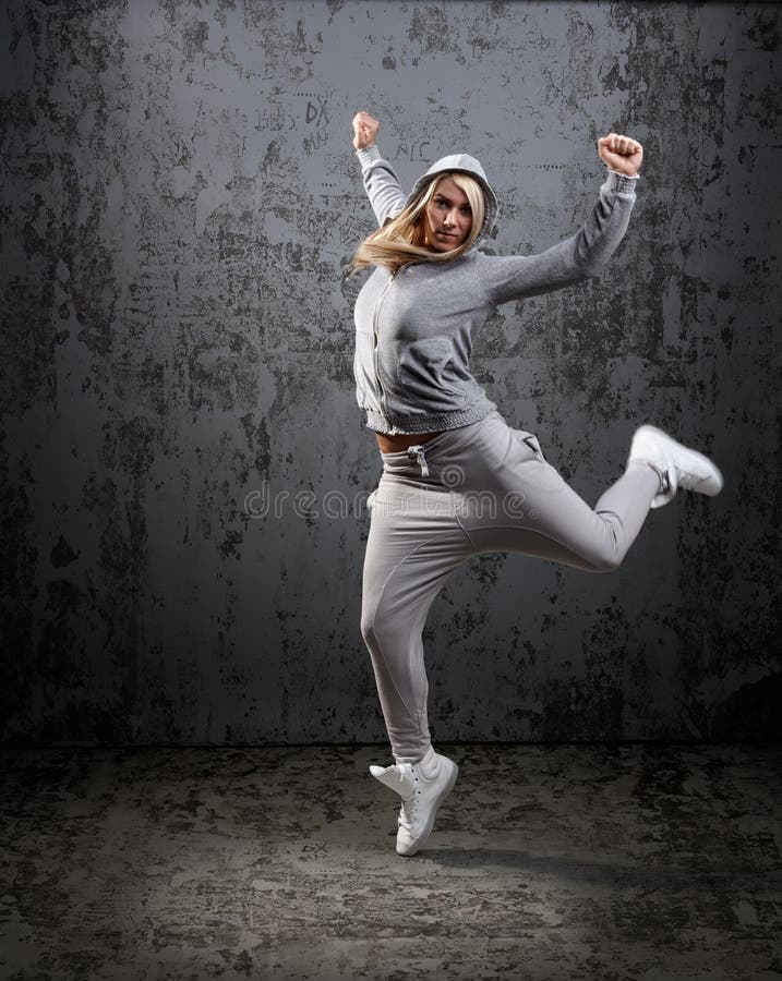 Urban hip hop dancer jumping and dancing with hoodie. Urban hip hop dancer jumping and dancing with hoodie