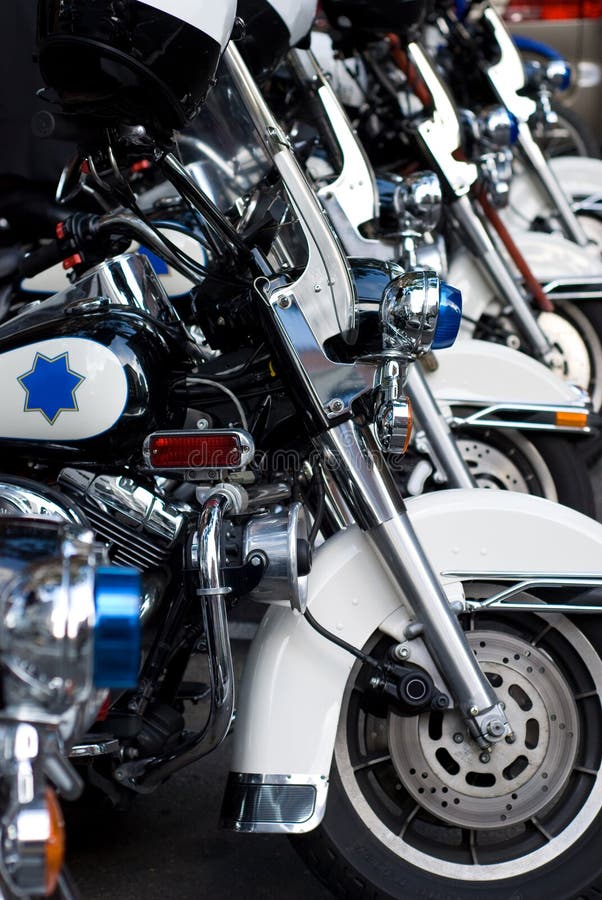 A row of parked Police motorcyles - symbol of order and security. A row of parked Police motorcyles - symbol of order and security.