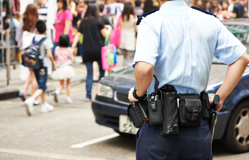 City security. policeman watching order in the urban street. City security. policeman watching order in the urban street