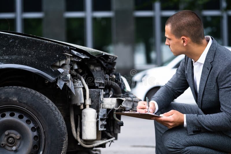 Insurance Agent Examining Car After Accident Or Crash. Insurance Agent Examining Car After Accident Or Crash