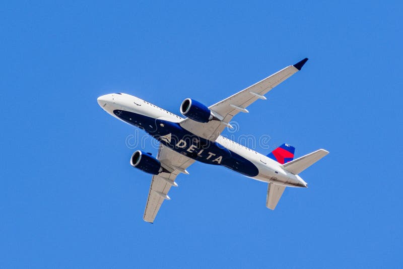 August 1, 2019 Santa Clara / CA / USA - Delta Airlines aircraft in flight; the Delta Logo visible on the airplanes` underbelly; blue sky background. August 1, 2019 Santa Clara / CA / USA - Delta Airlines aircraft in flight; the Delta Logo visible on the airplanes` underbelly; blue sky background