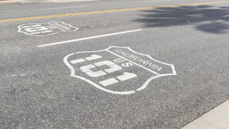 Pacific ocean Coast Highway road marking on asphalt, historic route 101, California State Route 1 roadtrip. Iconic emblem sign on freeway with dividing line in Oceanside, USA. Scenic road trip signage. Pacific ocean Coast Highway road marking on asphalt, historic route 101, California State Route 1 roadtrip. Iconic emblem sign on freeway with dividing line in Oceanside, USA. Scenic road trip signage