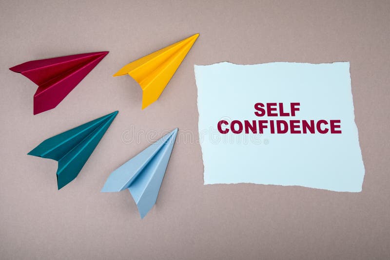 SELF CONFIDENCE. Text on note sheet, paper planes around, symbol of gaining goals, striving upwards. SELF CONFIDENCE. Text on note sheet, paper planes around, symbol of gaining goals, striving upwards