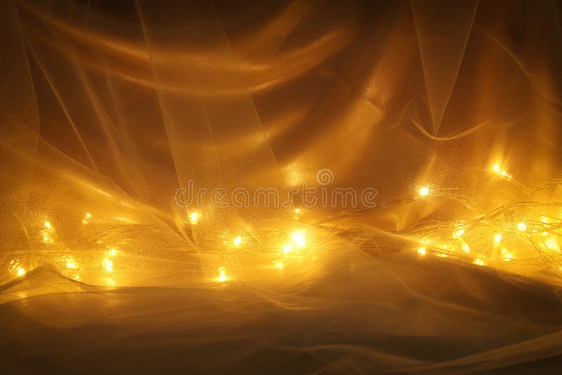 Abstract chiffon texture background with festive gold lights. Abstract chiffon texture background with festive gold lights