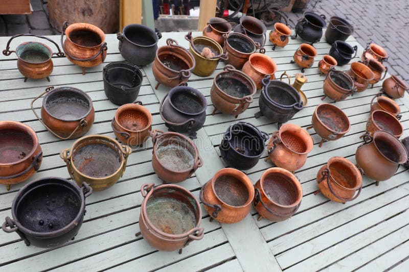 copper vases and cauldrons for sale in the antique dealer s stall in the alfresco flea market. copper vases and cauldrons for sale in the antique dealer s stall in the alfresco flea market