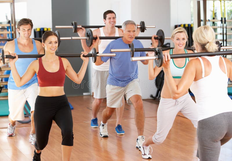 Group Of People Lifting Weights In Gym. Group Of People Lifting Weights In Gym