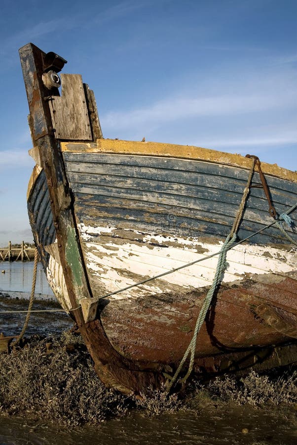 An old boat moored on the mud. An old boat moored on the mud