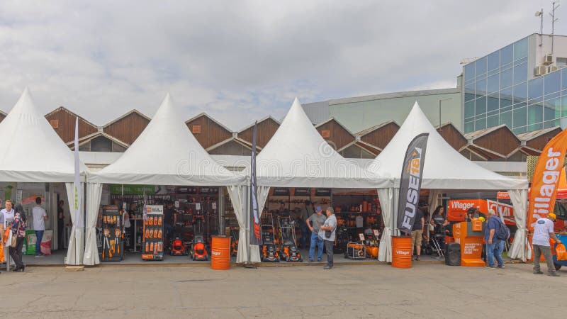 Novi Sad, Serbia - May 23, 2022: Fiskars Gardening Equipment and Villager Tools Stand Tent at Agriculture Trade Fair Expo. Novi Sad, Serbia - May 23, 2022: Fiskars Gardening Equipment and Villager Tools Stand Tent at Agriculture Trade Fair Expo