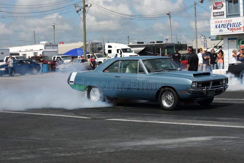 Napierville dragway august 23, 2014 picture of blue dodge dart on the track making a smoke show during drag show at john scotti all out event. Napierville dragway august 23, 2014 picture of blue dodge dart on the track making a smoke show during drag show at john scotti all out event.