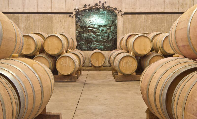 Stacks of wine barrels in a winery cellar. Stacks of wine barrels in a winery cellar.