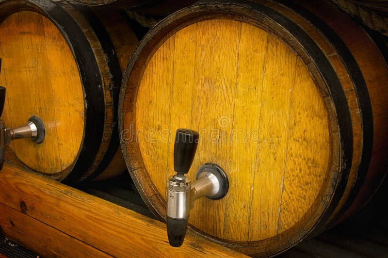 Two golden wooden casks or kegs with spouts sitting on a platform. Add your own text or copy to barrel. Two golden wooden casks or kegs with spouts sitting on a platform. Add your own text or copy to barrel.