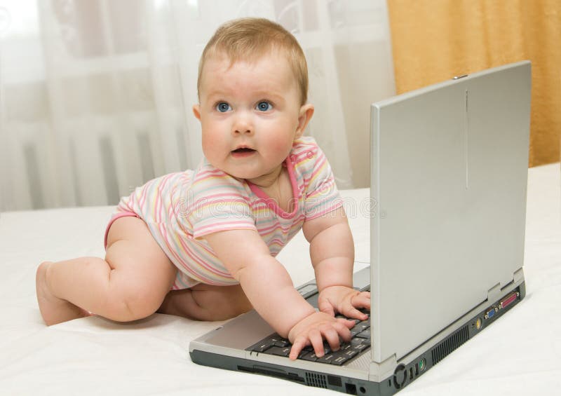 Small baby and laptop on bed #3. Small baby and laptop on bed #3