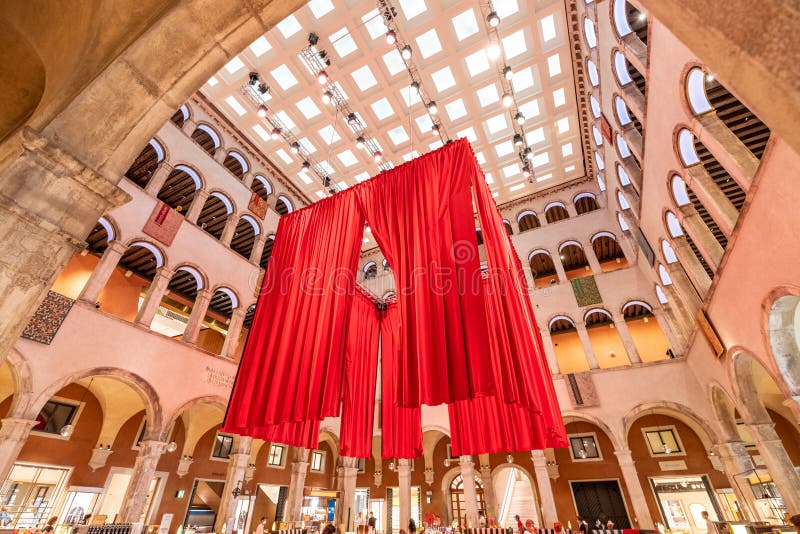 VENICE, ITALY - AUGUST 02, 2021: Huge indoor hall of Fondaco dei Tedeschi. Former headquarters and restricted living quarters of the German merchants. Today luxurious department store and cafe. Venice, Italy. VENICE, ITALY - AUGUST 02, 2021: Huge indoor hall of Fondaco dei Tedeschi. Former headquarters and restricted living quarters of the German merchants. Today luxurious department store and cafe. Venice, Italy.