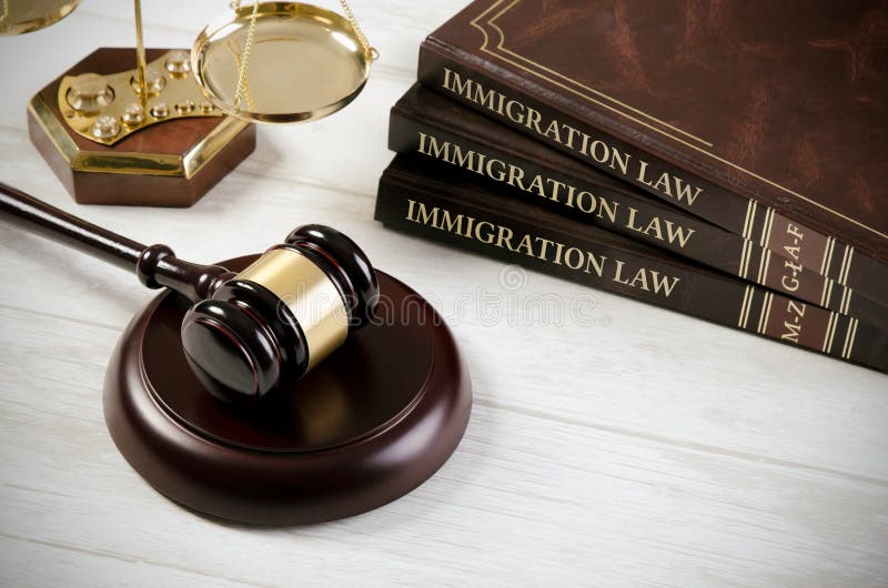 Immigration law book with judges gavel. Refugee citizenship law concept. Immigration law book with judges gavel. Refugee citizenship law concept