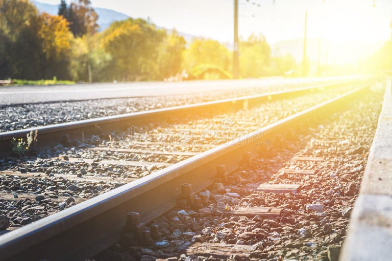 Landscape of an old abandoned railway in fall. Warm light, sustainable traveling, railroad, scenic, journey, track, dreamlike, environment, trip, discovery, climate, footprint, horizon, ecological, interrail, direction, target, ground, goods, traffic, perspective, industry, sunshine, transportation, voyage, nobody, idyll, train, logistic, sunbeam, vintage, stone, line, distance, ecologically, aware, sunlight, tourism, co2. Landscape of an old abandoned railway in fall. Warm light, sustainable traveling, railroad, scenic, journey, track, dreamlike, environment, trip, discovery, climate, footprint, horizon, ecological, interrail, direction, target, ground, goods, traffic, perspective, industry, sunshine, transportation, voyage, nobody, idyll, train, logistic, sunbeam, vintage, stone, line, distance, ecologically, aware, sunlight, tourism, co2