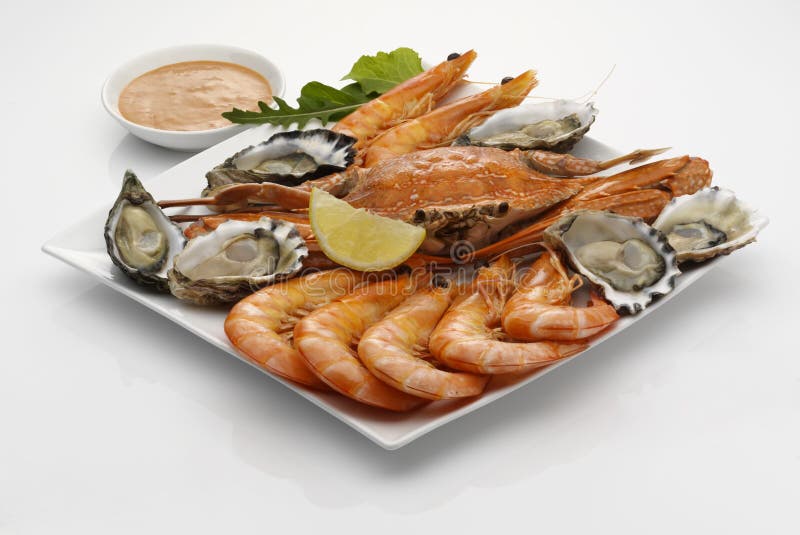 Seafood platter with dipping sauce on white background. Seafood platter with dipping sauce on white background.