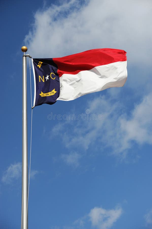 North Carolina State flag waving under sky. North Carolina State flag waving under sky