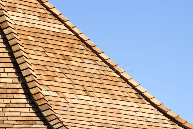 Layers of new cedar shingles on a roof. Layers of new cedar shingles on a roof