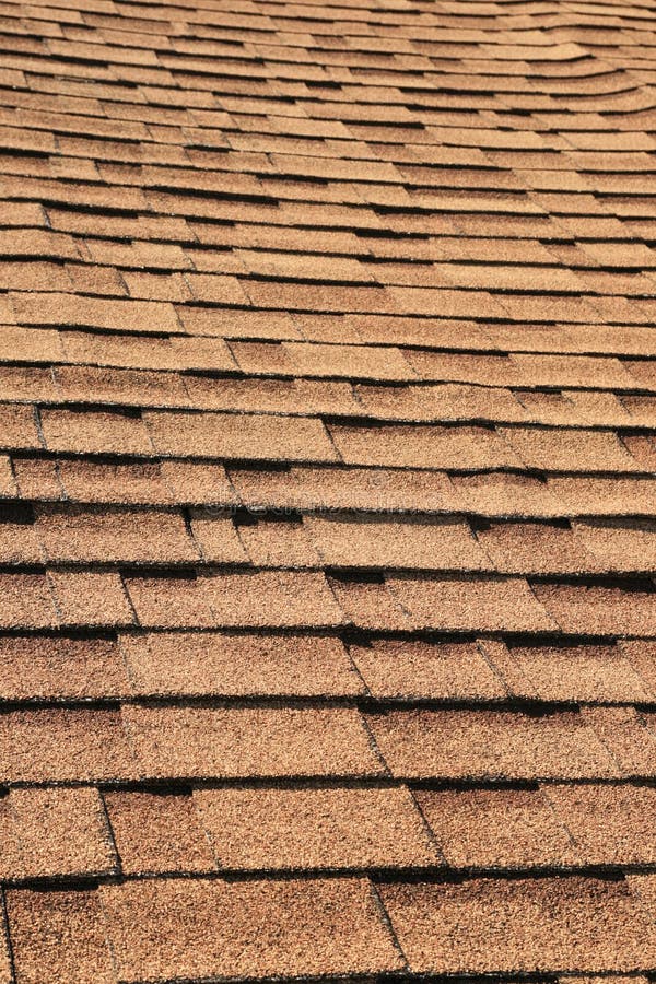 Vertical detail of brown roof shingles. Vertical detail of brown roof shingles