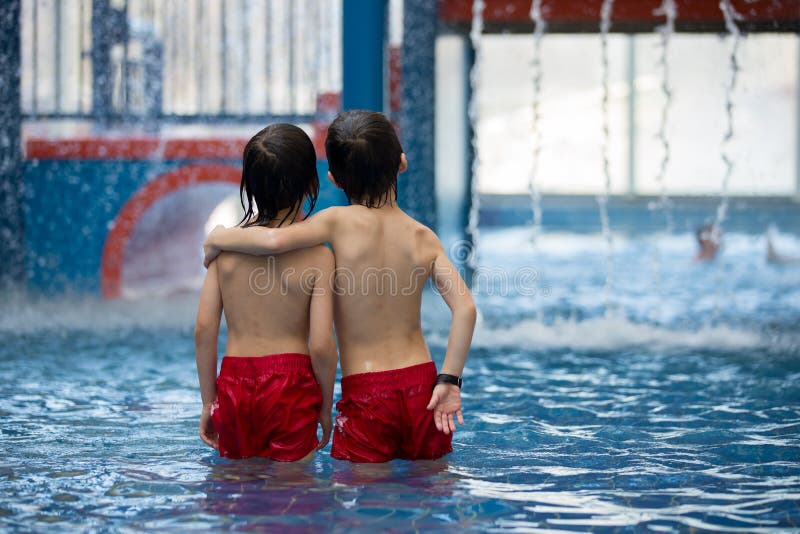 Sweet child, boy, playing in water world playground, enjoying attractions, swimming in a big swimming pool on a holiday. Sweet child, boy, playing in water world playground, enjoying attractions, swimming in a big swimming pool on a holiday