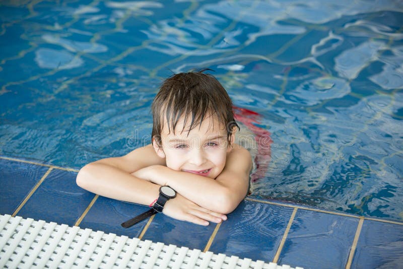 Sweet child, boy, playing in water world playground, enjoying attractions, swimming in a big swimming pool on a holiday. Sweet child, boy, playing in water world playground, enjoying attractions, swimming in a big swimming pool on a holiday