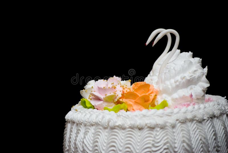 Wedding pie with figures of two swans. Isolate on black. Wedding pie with figures of two swans. Isolate on black