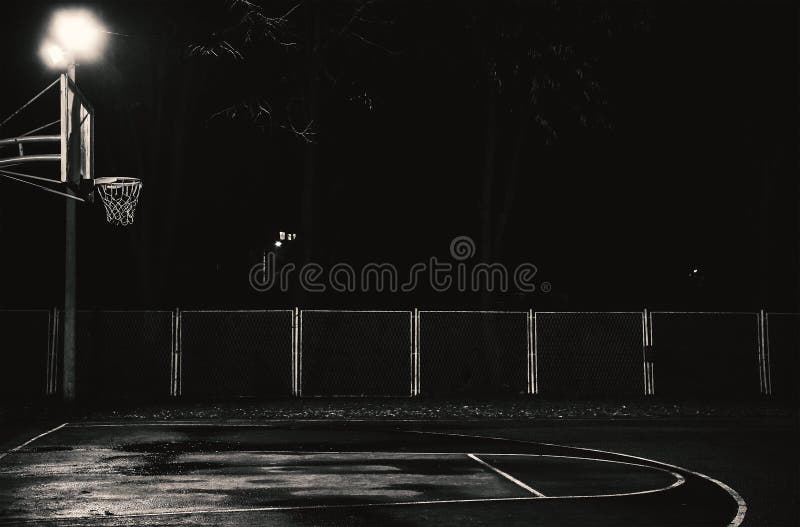 Emtpy basketball court by night, details of hoop and terrain. Emtpy basketball court by night, details of hoop and terrain.