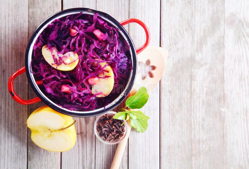 Aerial Shot of Gourmet Fresh Purple Cabbage and Apple Salad on Top of Wooden Table. Emphasizing Copy Space. Aerial Shot of Gourmet Fresh Purple Cabbage and Apple Salad on Top of Wooden Table. Emphasizing Copy Space.