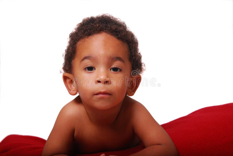 A multi-racial baby boy wrapped in a red blanket. A multi-racial baby boy wrapped in a red blanket.